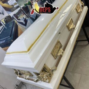 white casket with gold accent on top
